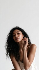 Young asian female with curly hair in minimalist portrait