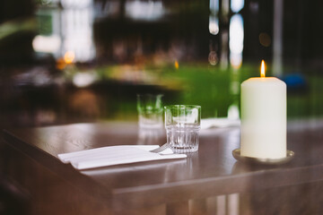 Cozy Dinner Table Setting with Candlelight and Glasses Capturing Serene Ambience in Elegant Restaurant