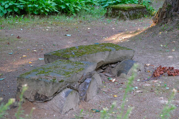two old benches made of wooden logs near cemetery