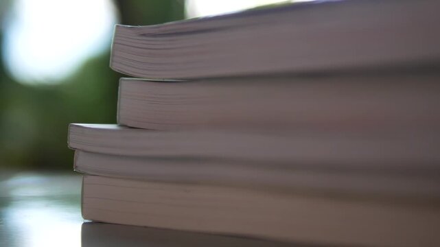 Stack of Books on Table with Blurred Background