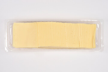 Rows of thinly sliced cheese slices are arranged in clear plastic packaging on a white background, photographed from above