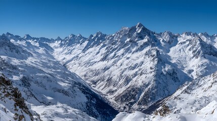 Obraz premium Snowy mountain peaks and valleys in winter.