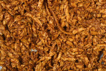 A pile of grated smoked tofu in a soy and mustard marinade creates a textured brown background