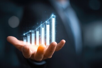 Businessperson's hand holds a glowing, upward-trending graph