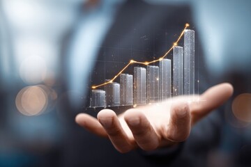 Businessperson holds a rising bar graph,  glowing in hand