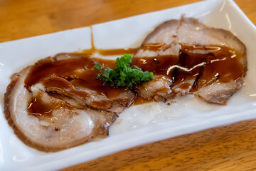 Chashu, a Japanese braised pork dish made with pork belly. It is a popular topping for ramen and other dishes.