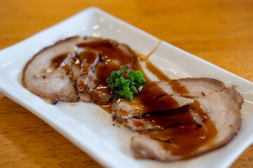 Chashu, a Japanese braised pork dish made with pork belly. It is a popular topping for ramen and other dishes.