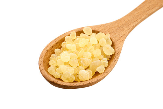 closeup pile of mastic gum or tear of chios in wood spoon cutout