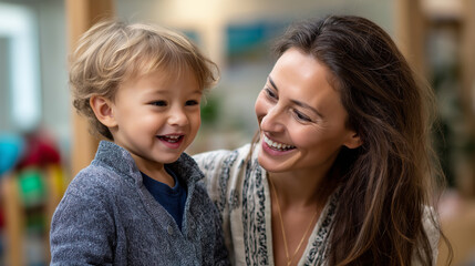 A joyful mother and toddler laughing together in a playroom