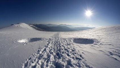 Snowy mountain pass, footprints, sunlit