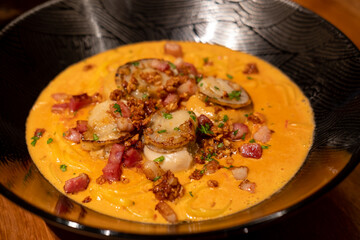 Spaghetti creamy tomato sauce with bacon scallop served on a plate. Soft Focus.