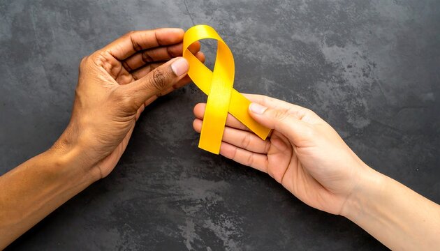 Diverse Hands Holding Golden Ribbon: Symbolizing Suicide Prevention, Childhood Cancer Awareness and World Cancer Day	