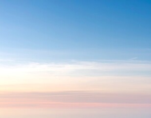 Obraz premium Pastel sunset hues paint the horizon, blending softly into a clear, light blue sky with wispy clouds