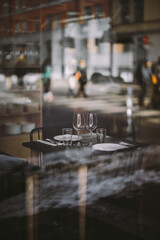 Chic Urban Restaurant Setting with Reflections in Large City Windows Creating a Stylish Ambiance