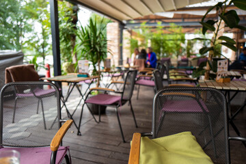 Cozy Urban Outdoor Cafe with Modern Seating and Lush Greenery Creating a Relaxed Atmosphere for Casual Dining and Social Gatherings