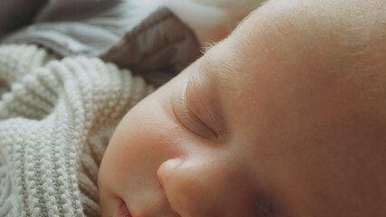 Newborn baby sleeping peacefully on soft blanket