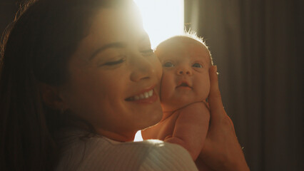 Mother holding her newborn baby with love and tenderness