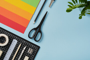 Colorful craft supplies on a blue background with copyspace for your text. Concept of creativity, design, and art projects