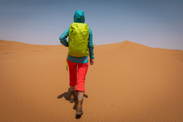 Backpacking woman hiking  in the desert