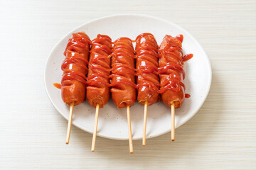fried sausage skewer with ketchup