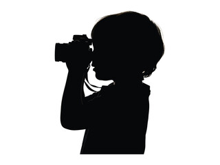 Silhouette of Budding Photographer: Capturing the essence of childhood curiosity, a young child stands focused, peering through the lens of a camera, igniting the spark of creativity. 