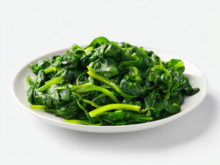 Freshly cooked green spinach served on a white plate with a glossy finish