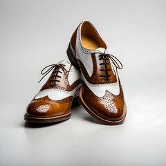 Elegant brown and white leather brogue shoes isolated on white background