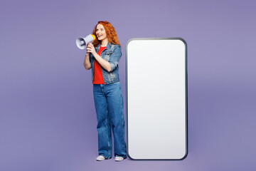 Full body young ginger woman she wears red t-shirt denim shirt big huge blank screen mobile cell...