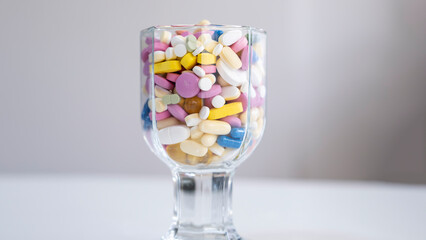 Pills, tablets, capsules, vitamins and omega3 in the glass