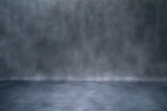 A close-up of a dark, textured surface with a subtle. The varying shades of grey and black create a dramatic and moody background, perfect for use as a backdrop or abstract wallpaper.