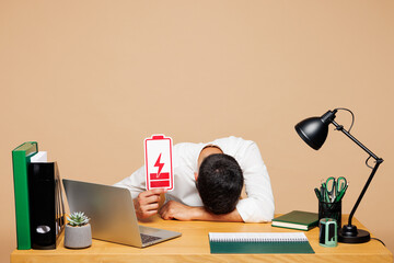 Young tired employee business man wear white shirt tie sit work put head on office desk with pc...