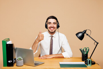 Smiling employee operator business man in set microphone headset for helpline assistance sit work...