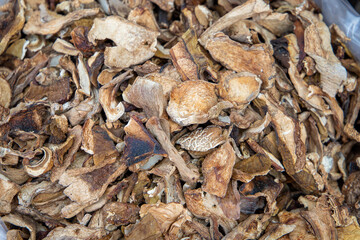 Dried porcini mushrooms close-up. Selling porcini mushrooms at the market in bulk in a bag. Full frame. Top view. Cooking. Vegetarianism.
