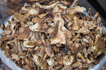Dried porcini mushrooms close-up. Selling porcini mushrooms at the market in bulk in a bag. Full frame. Top view. Cooking. Vegetarianism.