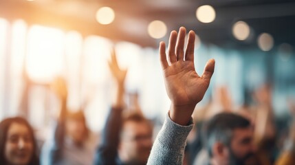 Obraz premium Audience members raising their hands during a conference, demonstrating active participation and engagement in a corporate event