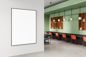 Blank poster mockup in modern bright interior with green walls, red chairs, and wooden shelves,...