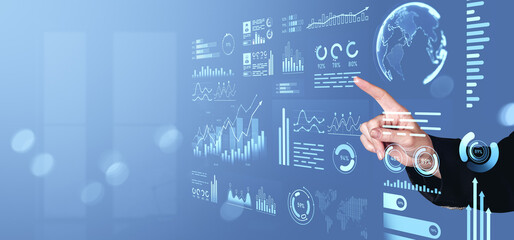 Business analytics dashboard with hand interacting with futuristic interface.