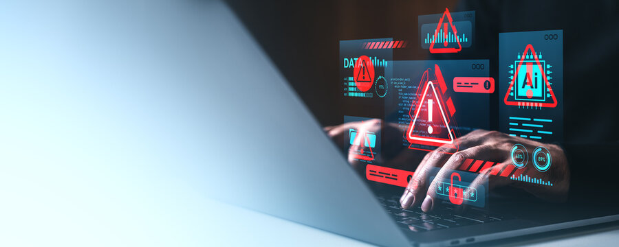 Cybersecurity warning concept showing hands typing on a laptop with red alert symbols and data breach indicators on a high-tech screen interface..
