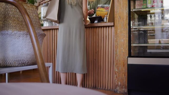 Customer standing at cafe counter