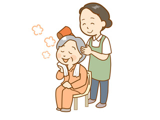 高齢者の入浴後に髪を乾かす介護士