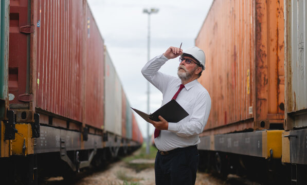 Engineer manager and a secretary working together railway track during inspection or routine maintenance container industrial or transportation setting the rail train import export logistics