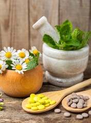 Alternative medicine herbal capsule organic drug on wooden background.Assortment of herbal and tablets,vitamins and dietary supplements.medicinal and Healing herbs.natural supplements for healthy life