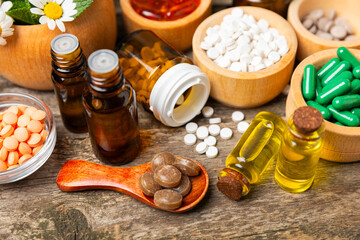 Alternative medicine herbal capsule organic drug on wooden background.Assortment of herbal and tablets,vitamins and dietary supplements.medicinal and Healing herbs.natural supplements for healthy life