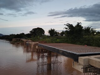 Evening view of the bridge building along river on background