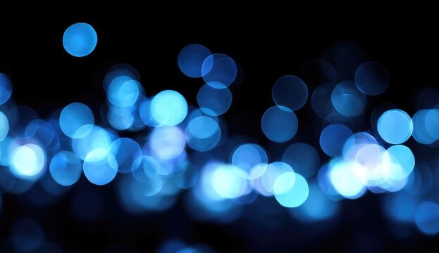 Abstract bokeh lights, vibrant blue circles on black background (1)