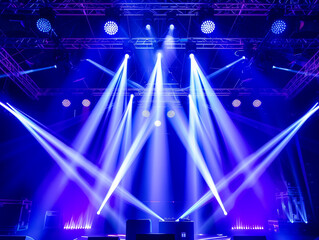 Overhead shot of a stage with complex lighting rig, blue and purple beams creating dramatic ambiance, technical precision, cinematic clarity