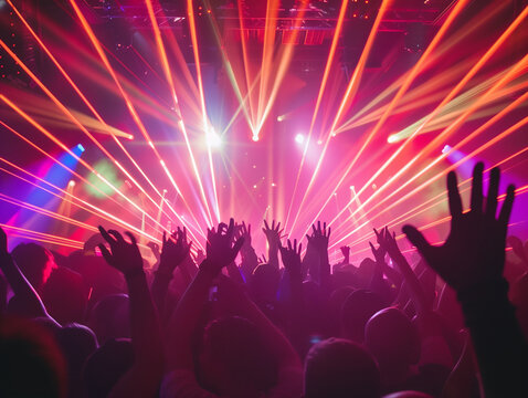 Energetic crowd dancing on a packed nightclub dancefloor, vibrant LED lights, colorful strobes, hands in the air