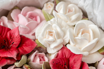 Beautiful arrangement of artificial flowers featuring pink, white, and red blooms nestled in soft...