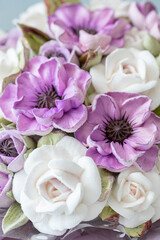 Beautiful arrangement of delicate purple and white flowers with intricate details, showcasing artistry and craftsmanship in floral design, perfect for decoration or gifting