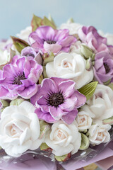 Beautiful bouquet featuring delicate purple and white flowers arranged artistically, showcasing intricate details and textures, perfect for celebrations or decorative purposes